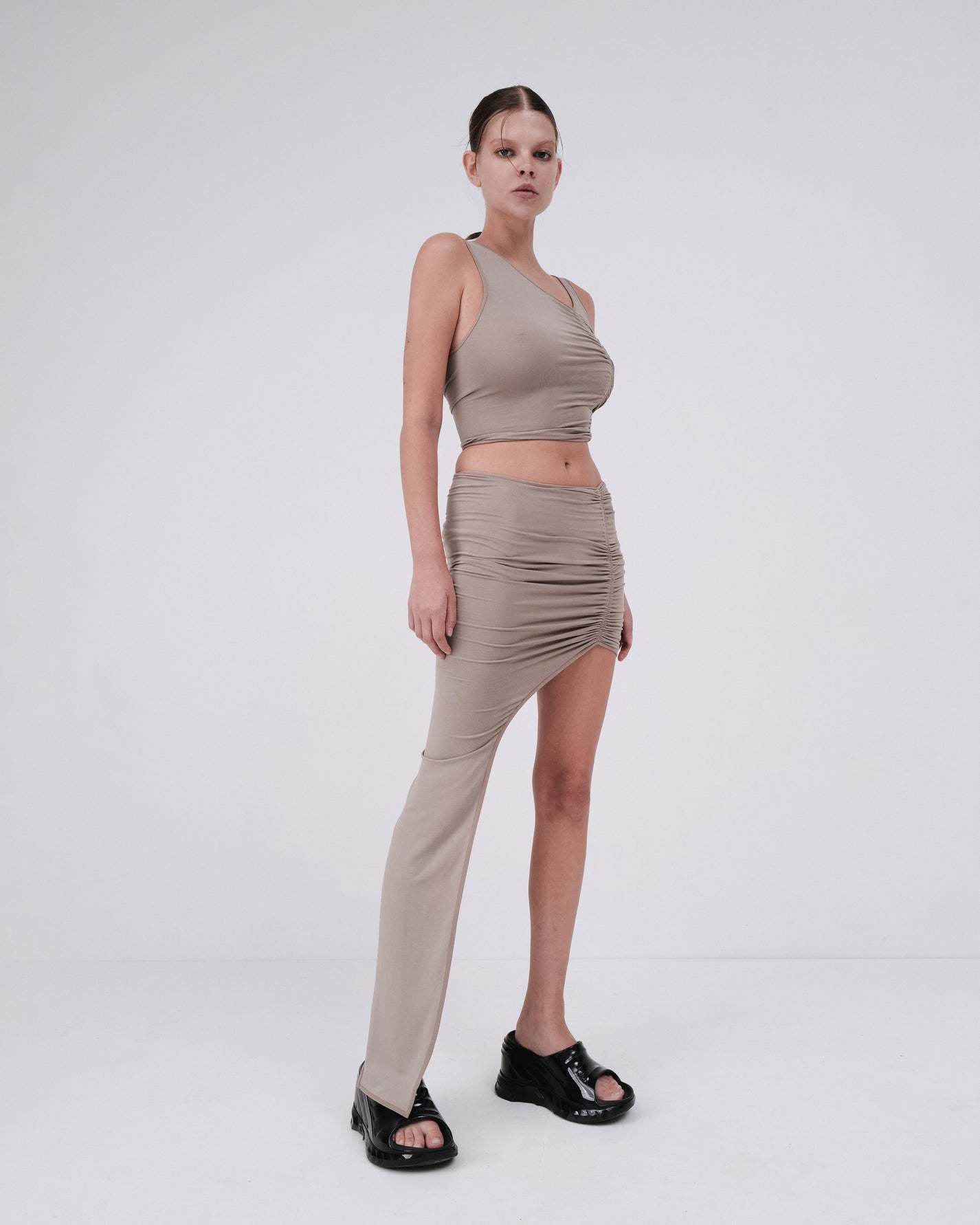DRAPED SKIRT WITH ELONGATED DETAIL IN DUST BEIGE